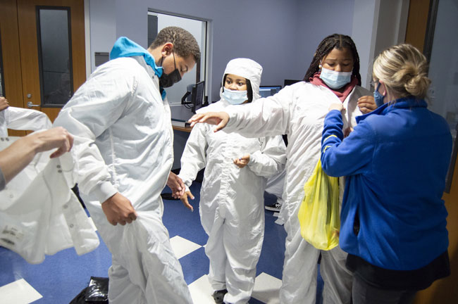 Students getting into clean-room suits